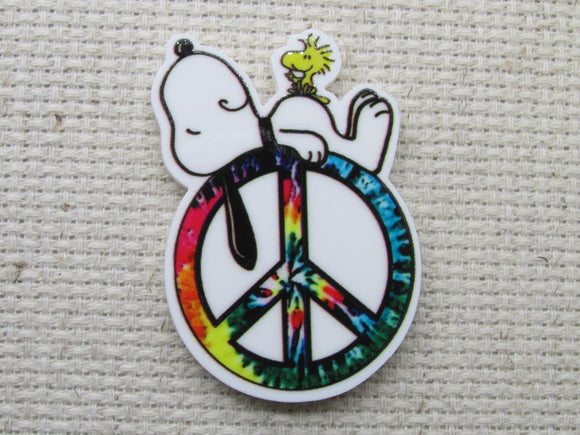 First view of Snoopy on a peace sign needle minder. 