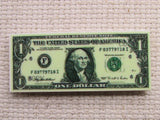 Second view of 1 dollar bill needle minder.