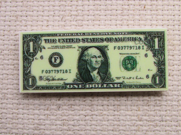 First view of 1 dollar bill needle minder.