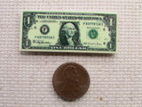 Third view of 1 dollar bill needle minder.