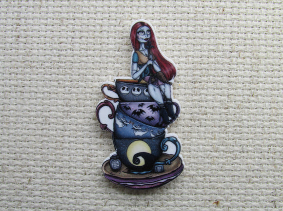 First view of Sally Sitting on a Stack of Teacups Needle Minder.