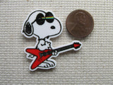 Second view of Snoopy Playing a Guitar Needle Minder.