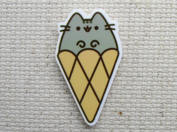 First view of grey cartoon cat in an ice cream cone needle minder.