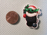 Second view of alien child in a Christmas stocking needle minder.