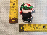 Third view of alien child in a Christmas stocking needle minder.