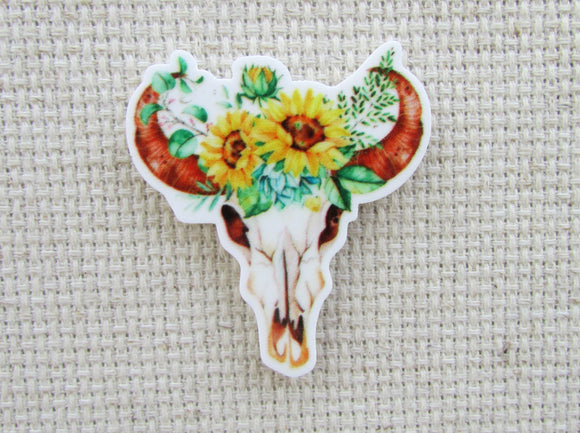 First view of bull skull adorned with sunflowers needle minder.