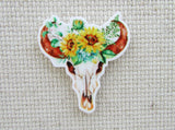 First view of bull skull adorned with sunflowers needle minder.