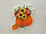 First view of a flower filled pumpkin needle minder.