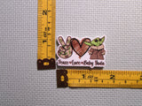 Third view of peace love baby Yoda needle minder.